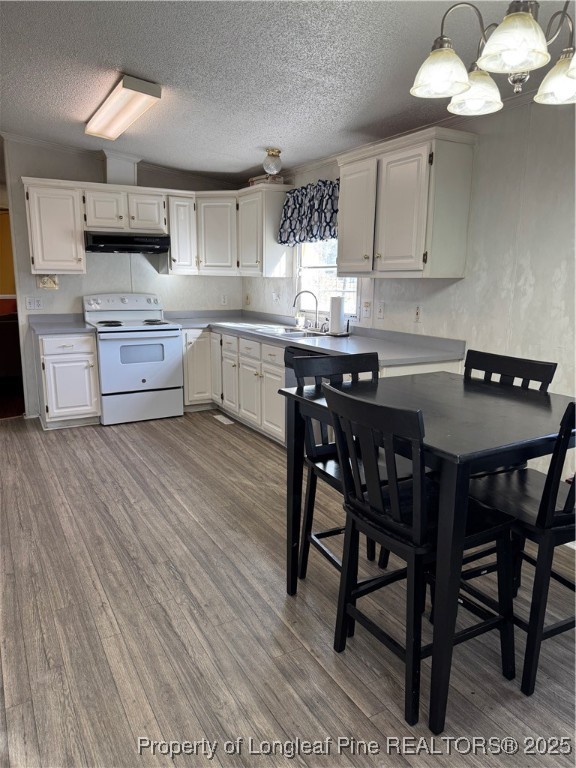 3082 Alamac Road Lumberton, NC 28358 - Photo 13 of 30 a kitchen with stainless steel appliances granite countertop a sink dishwasher a stove a dining table and chairs with wooden floor