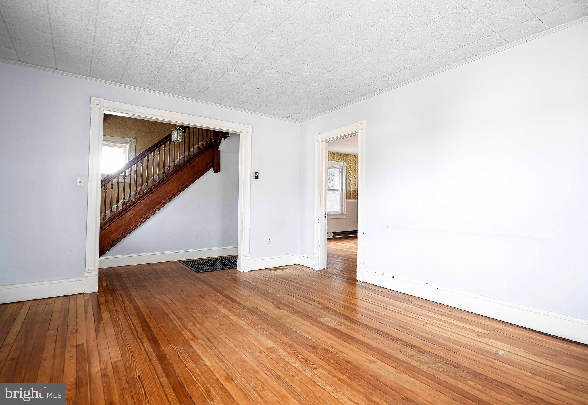 1531 Perryman Road Aberdeen, MD 21001 - Photo 6 of 23 a view of an empty room with wooden floor and stairs