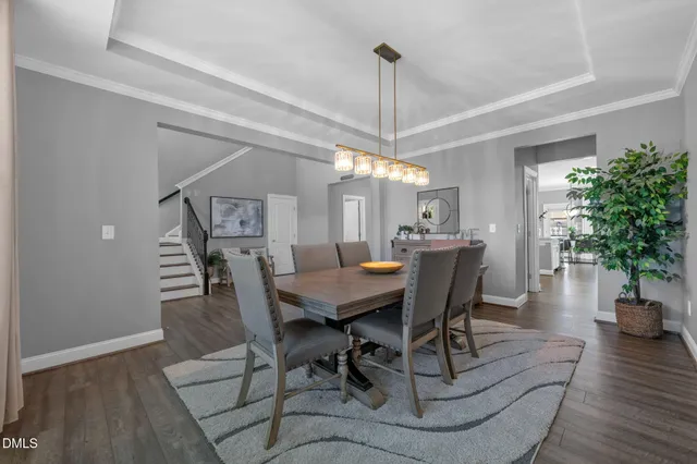 a kitchen with stainless steel appliances a refrigerator and a hard wood floor