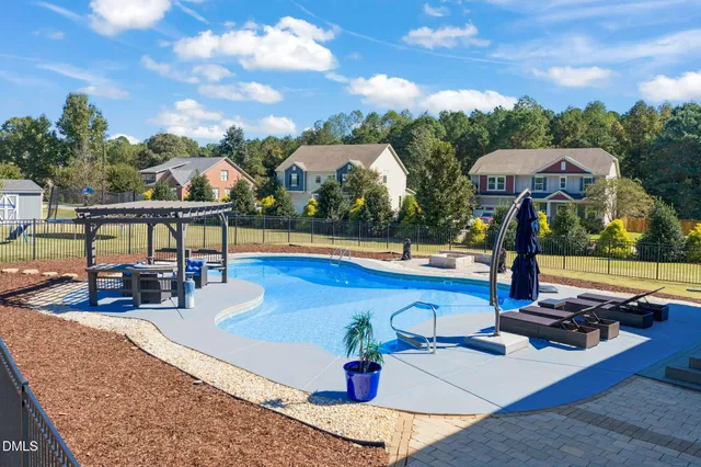 a view of a swimming pool with an outdoor seating