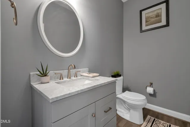 a spacious bathroom with a tub sink and a mirror