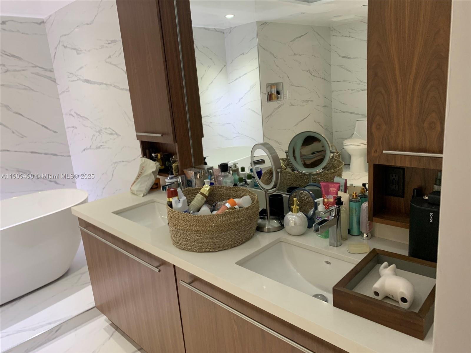 9401 Collins Avenue, Unit 305 Surfside, FL 33154 - Photo 12 of 17 a kitchen with a sink and a stove with wooden floor