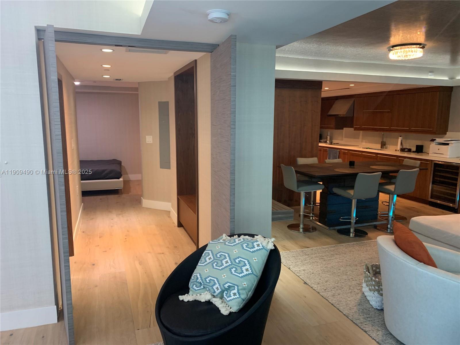 9401 Collins Avenue, Unit 305 Surfside, FL 33154 - Photo 9 of 17 a living room with furniture and a flat screen tv