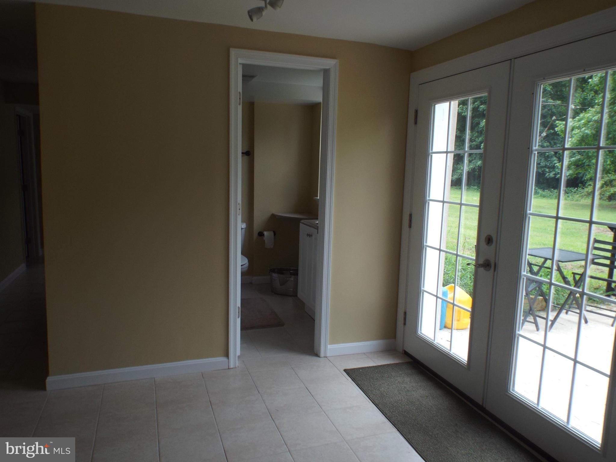 1825 Joe Harris Road Prince Frederick, MD 20678 - Photo 27 of 30 French door and tiled foyer leading to rear