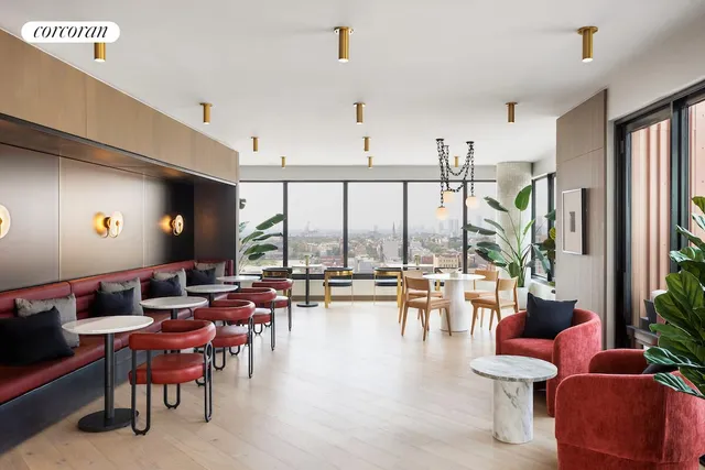 a living room with lots of furniture and a large window