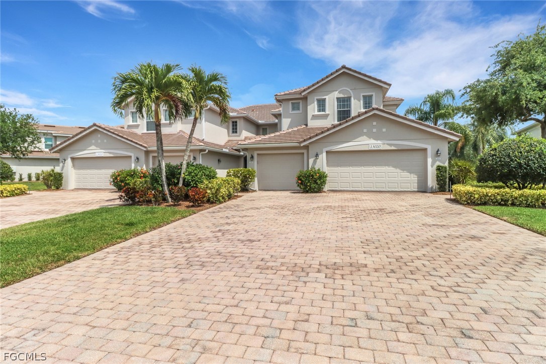 13020 Pebblebrook Point Circle, Unit 202 Fort Myers, FL 33905 - Photo 1 of 40 a front view of a house with a yard and potted plants