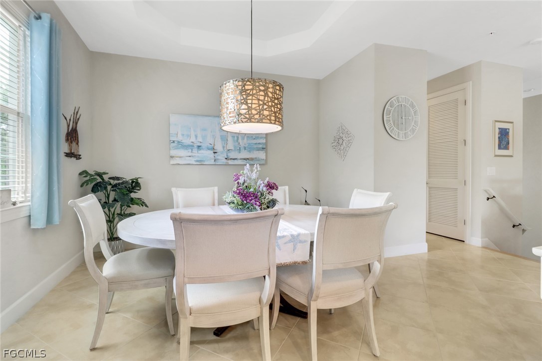 13020 Pebblebrook Point Circle, Unit 202 Fort Myers, FL 33905 - Photo 11 of 40 a dining room with furniture a chandelier and window