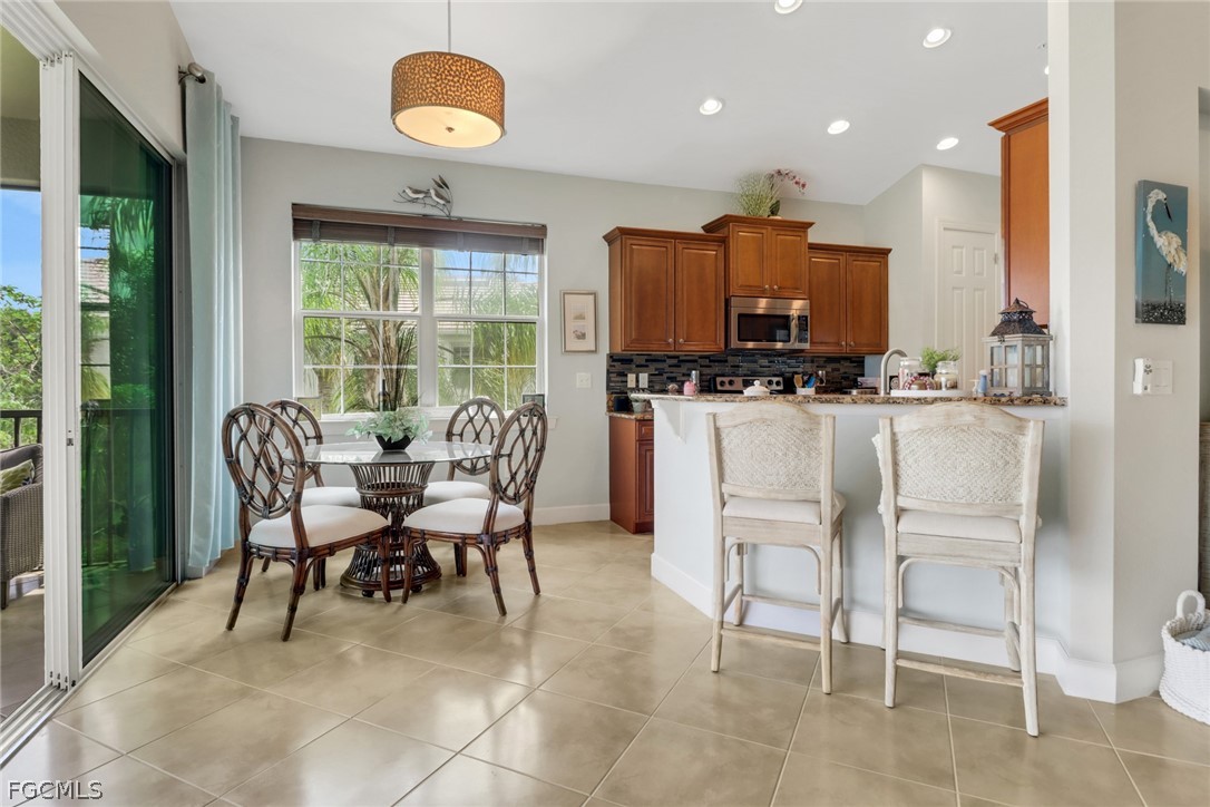 13020 Pebblebrook Point Circle, Unit 202 Fort Myers, FL 33905 - Photo 12 of 40 a view of a dining room with furniture window and outside view
