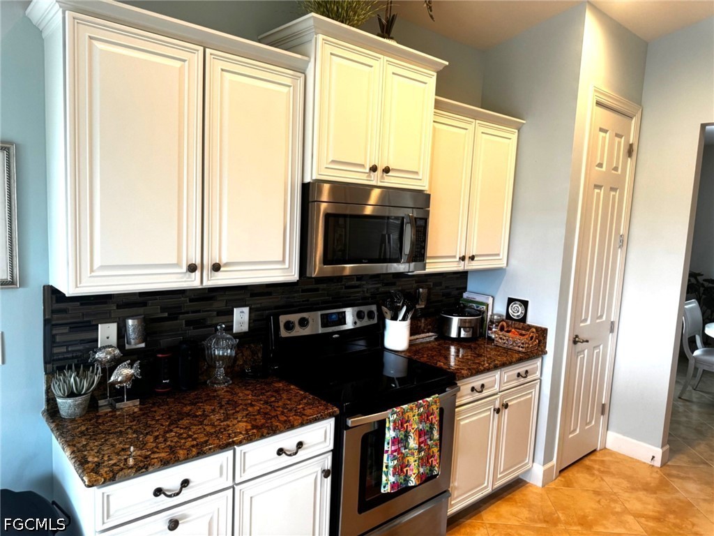 13020 Pebblebrook Point Circle, Unit 202 Fort Myers, FL 33905 - Photo 13 of 40 a kitchen with stainless steel appliances granite countertop a sink and a stove