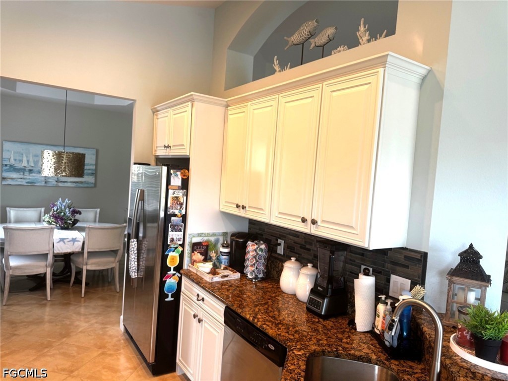 13020 Pebblebrook Point Circle, Unit 202 Fort Myers, FL 33905 - Photo 14 of 40 a kitchen with a refrigerator and dining table