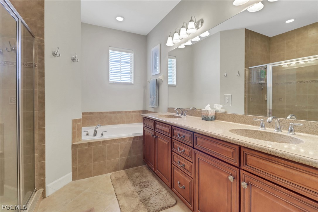 13020 Pebblebrook Point Circle, Unit 202 Fort Myers, FL 33905 - Photo 19 of 40 a spacious bathroom with a tub sink and mirror