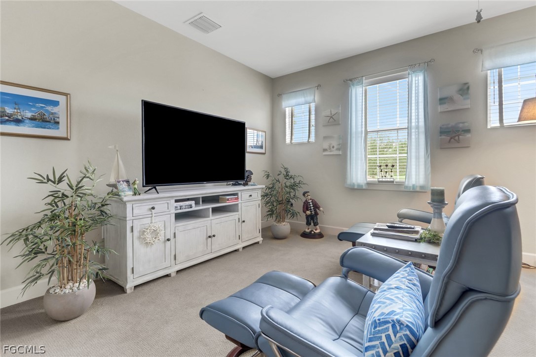 13020 Pebblebrook Point Circle, Unit 202 Fort Myers, FL 33905 - Photo 21 of 40 a living room with furniture and a flat screen tv