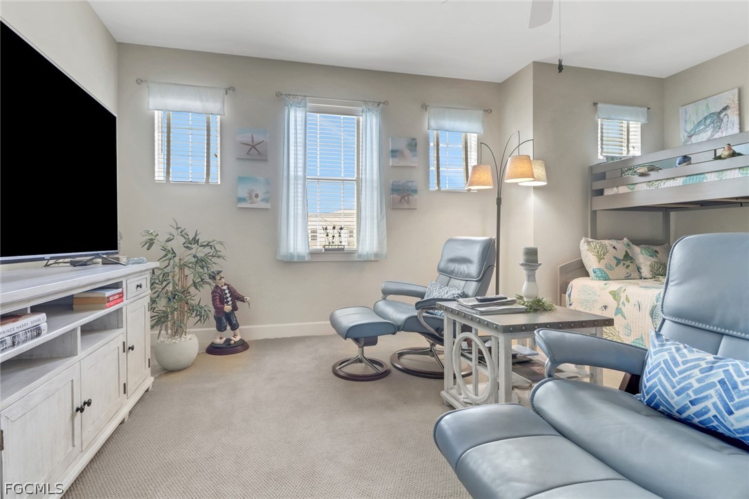 13020 Pebblebrook Point Circle, Unit 202 Fort Myers, FL 33905 - Photo 22 of 40 a living room with furniture and a flat screen tv
