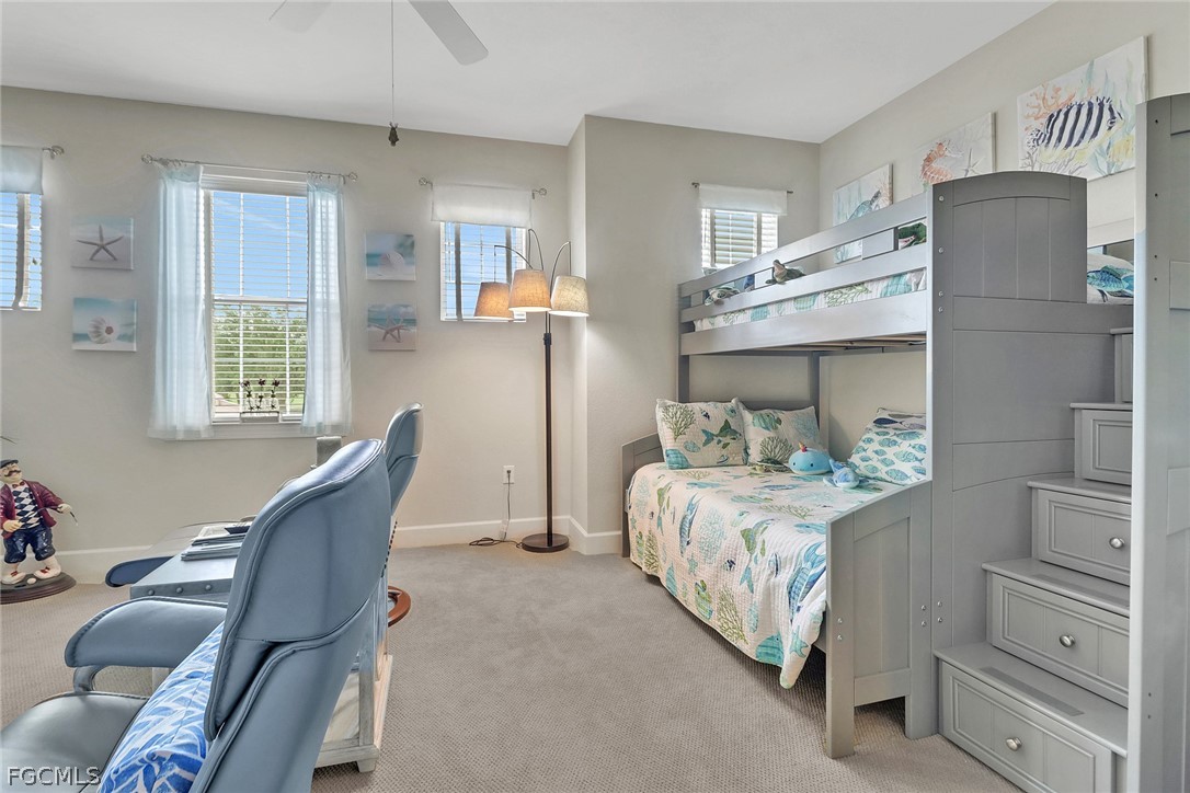 13020 Pebblebrook Point Circle, Unit 202 Fort Myers, FL 33905 - Photo 24 of 40 a bed room with a bed and a chair