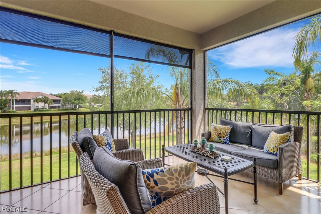 13020 Pebblebrook Point Circle, Unit 202 Fort Myers, FL 33905 - Photo 3 of 40 a balcony with furniture and wooden floor