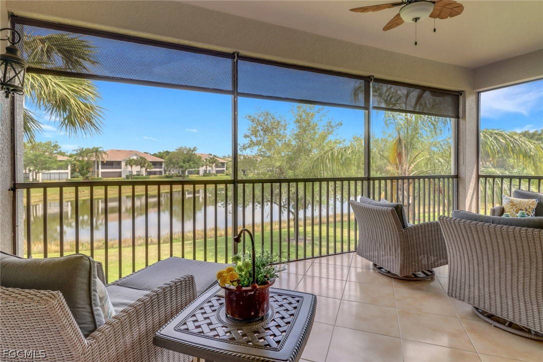 13020 Pebblebrook Point Circle, Unit 202 Fort Myers, FL 33905 - Photo 4 of 40 a living room with furniture and a floor to ceiling window