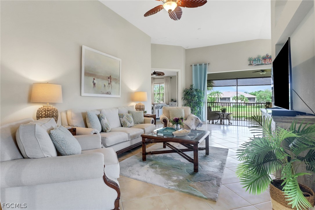 13020 Pebblebrook Point Circle, Unit 202 Fort Myers, FL 33905 - Photo 8 of 40 a living room with furniture and a flat screen tv