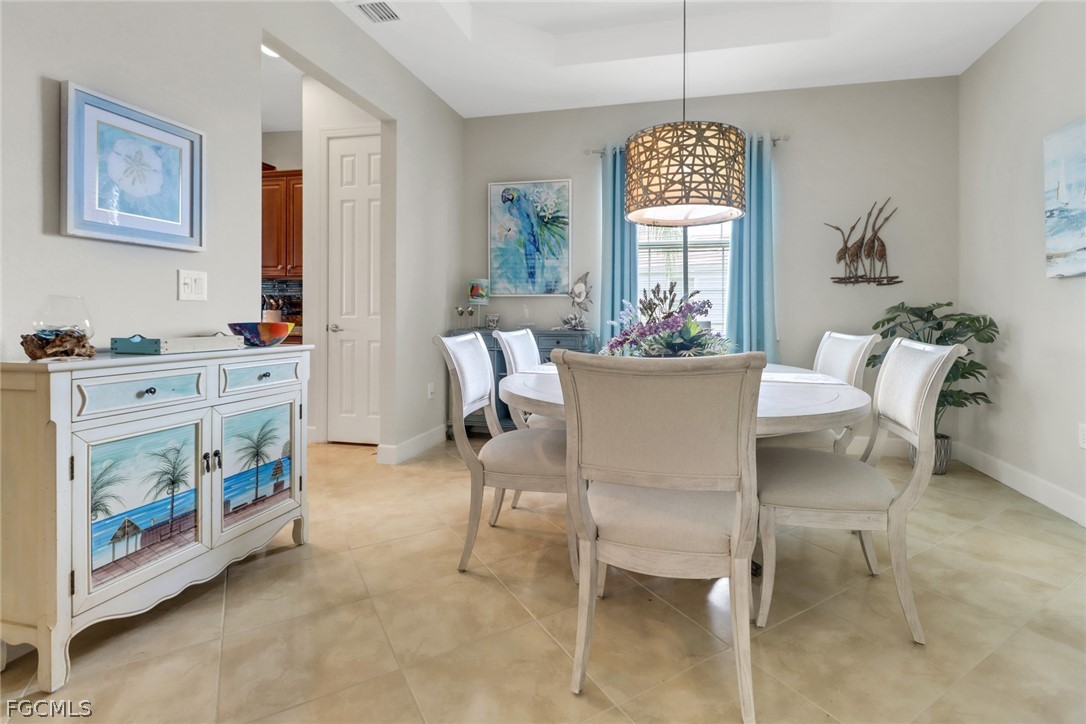 13020 Pebblebrook Point Circle, Unit 202 Fort Myers, FL 33905 - Photo 10 of 40 a dining room with furniture a livingroom and chandelier