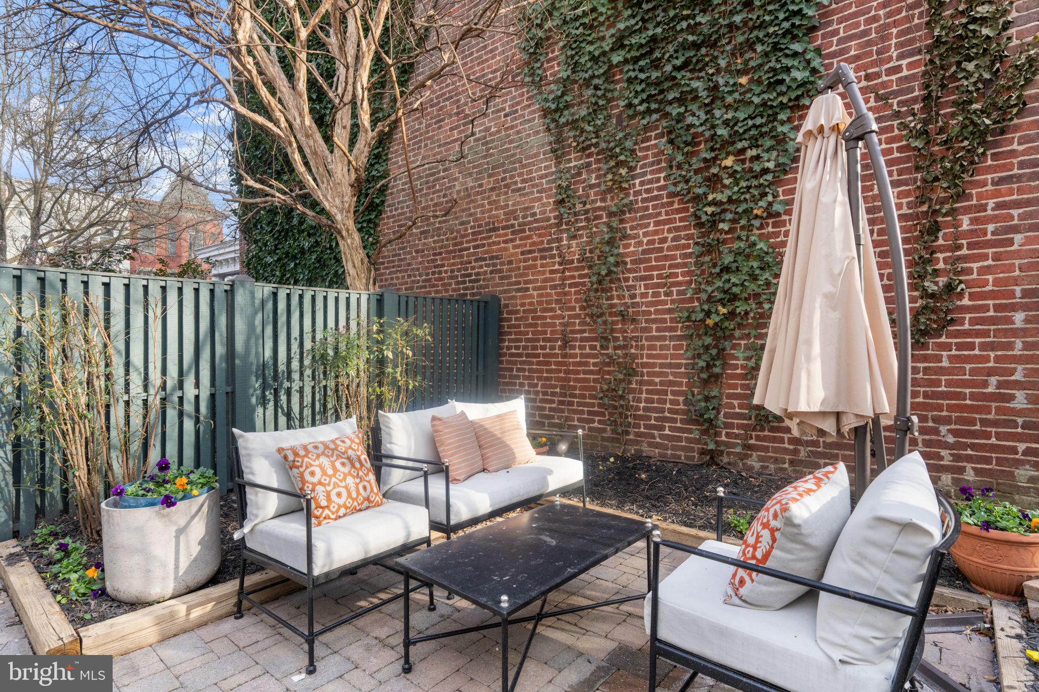 1802 Lamont Street Northwest Washington, DC 20010 - Photo 108 of 118 a view of a patio with a table and chairs