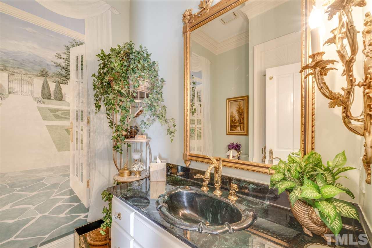 1112 Hymettus Court Raleigh, NC 27607 - Photo 11 of 29 a bathroom with a sink a mirror and a shower