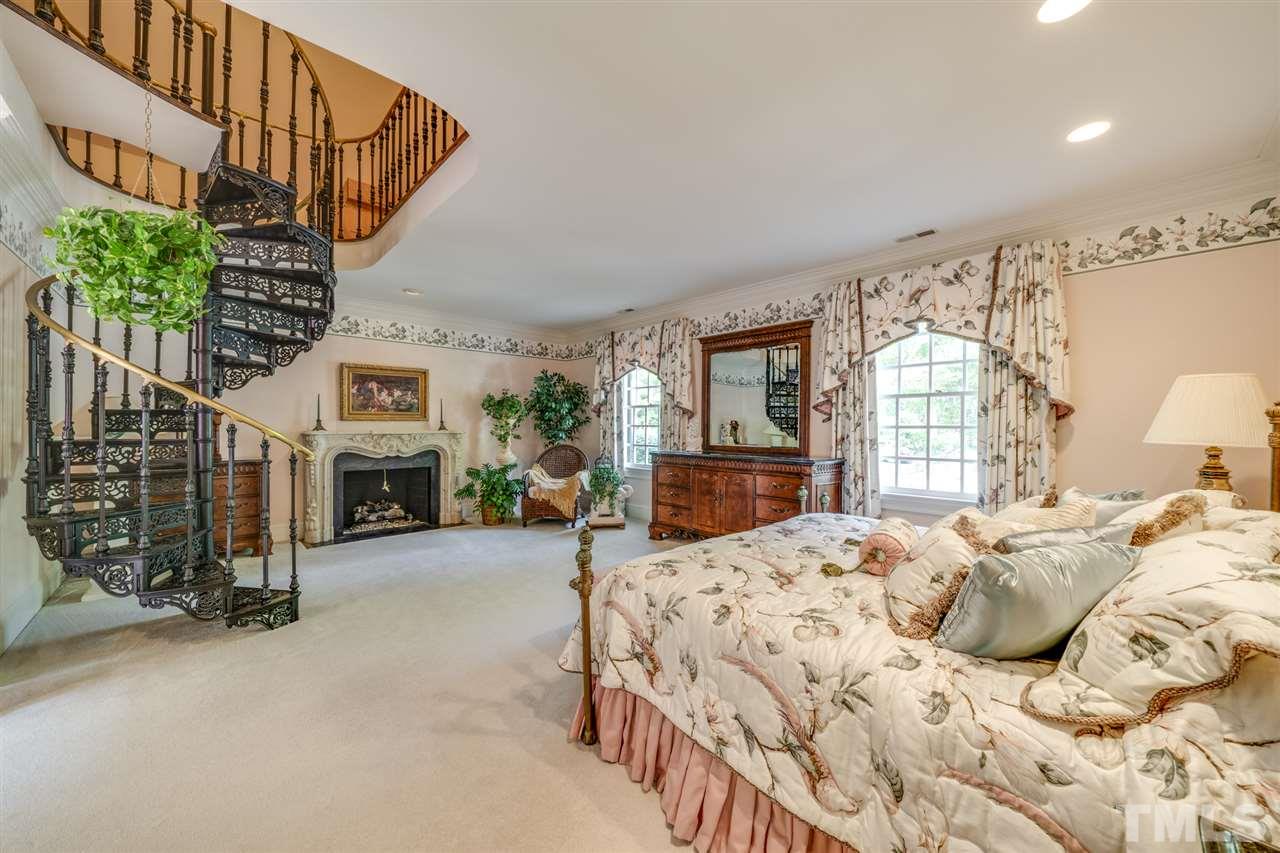 1112 Hymettus Court Raleigh, NC 27607 - Photo 13 of 29 a bed room with a bed and a fireplace