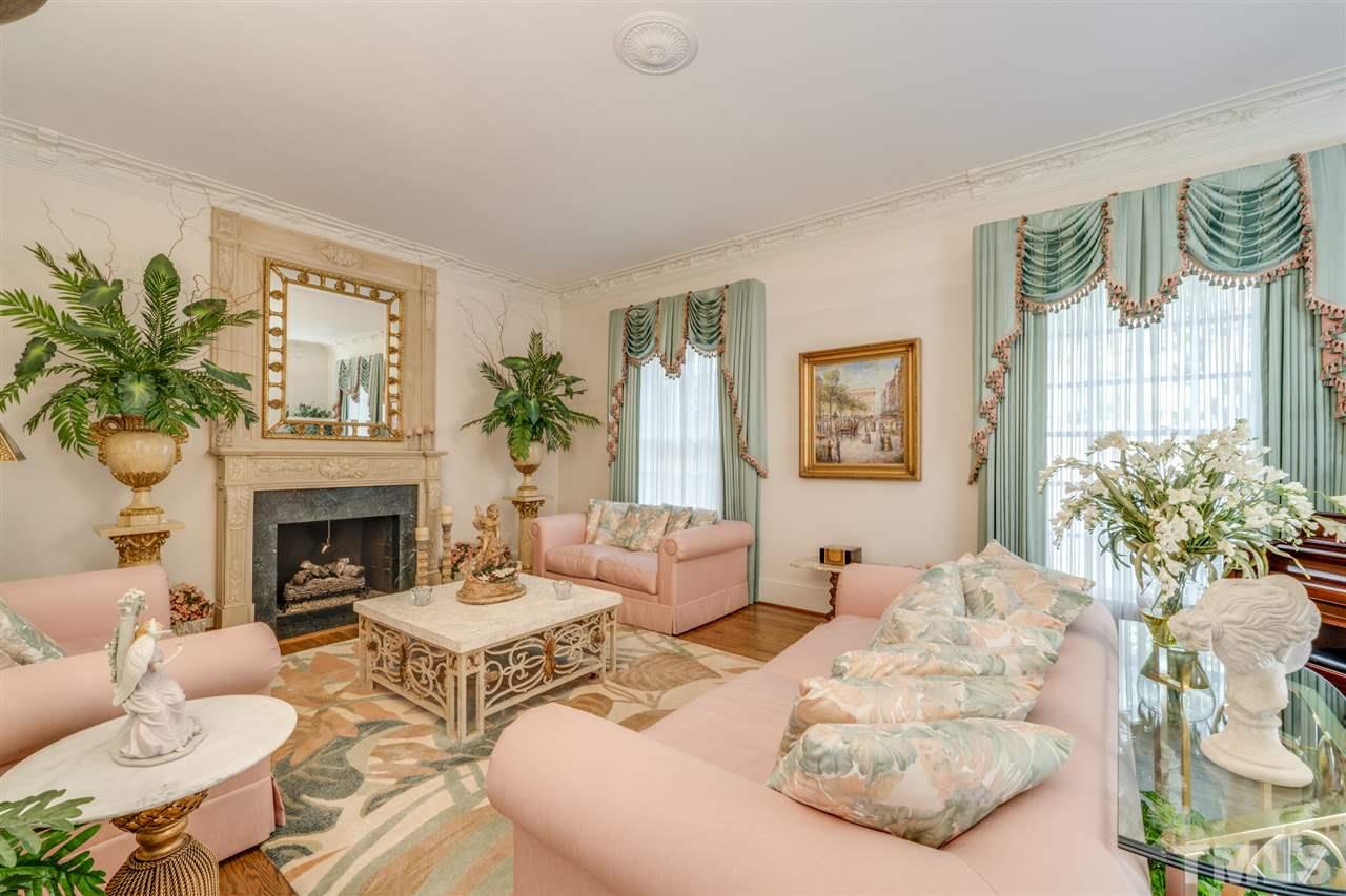1112 Hymettus Court Raleigh, NC 27607 - Photo 4 of 29 a living room with furniture a fireplace and a potted plant