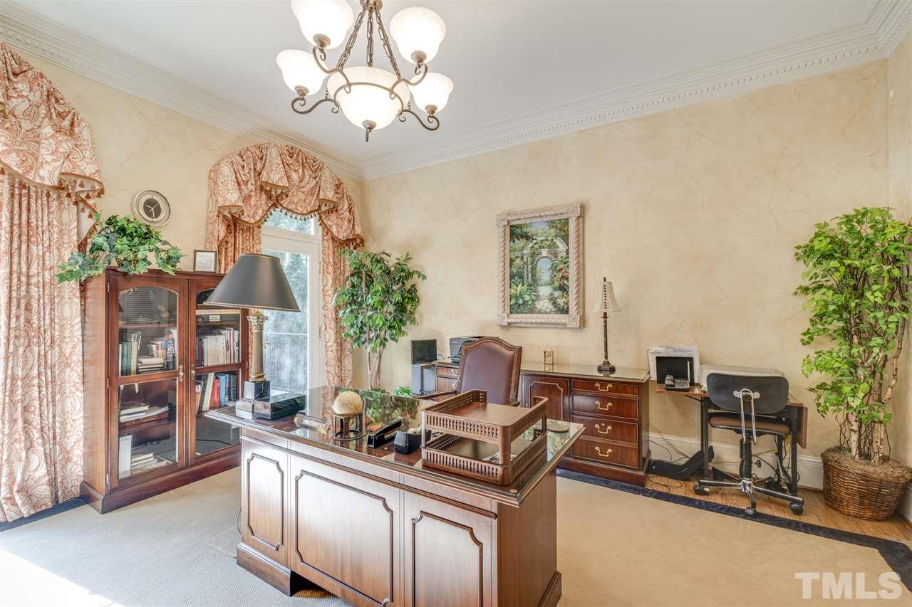 1112 Hymettus Court Raleigh, NC 27607 - Photo 10 of 29 a living room with furniture a chandelier and a fireplace