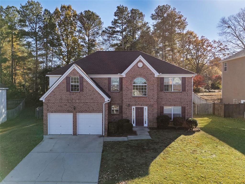 3017 Bellingham Way Lithia Springs, GA 30122 - Photo 1 of 44 a front view of a house with a yard and garage