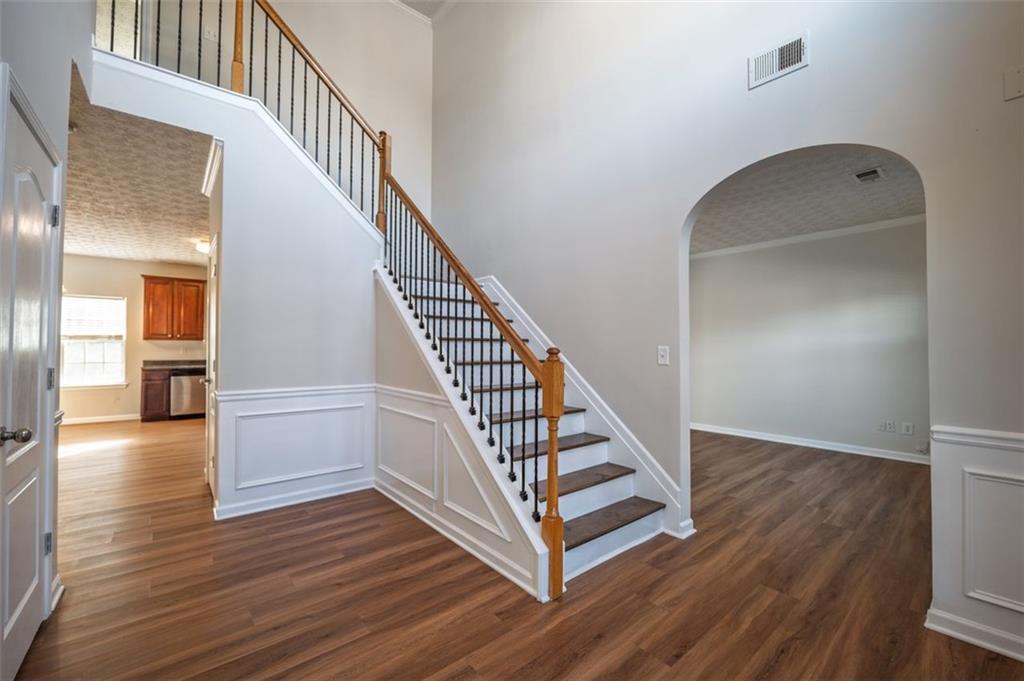 3017 Bellingham Way Lithia Springs, GA 30122 - Photo 11 of 44 a view of a hallway with wooden floor and staircase
