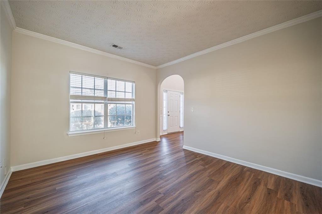 3017 Bellingham Way Lithia Springs, GA 30122 - Photo 16 of 44 an empty room with wooden floor and windows