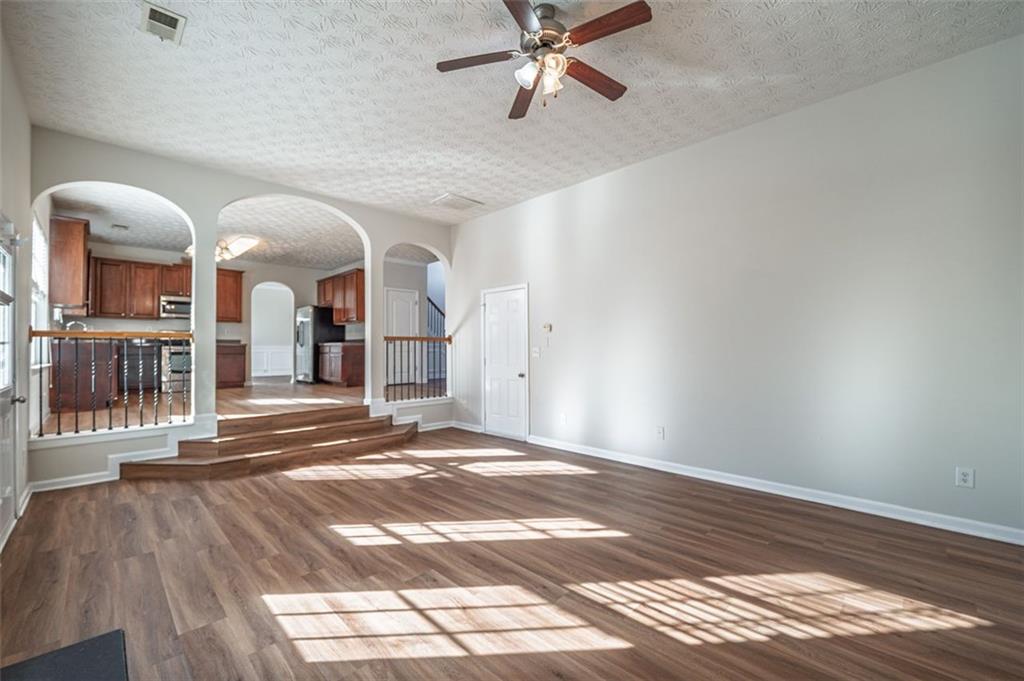 3017 Bellingham Way Lithia Springs, GA 30122 - Photo 19 of 44 a view of a hallway with wooden floor and a chandelier