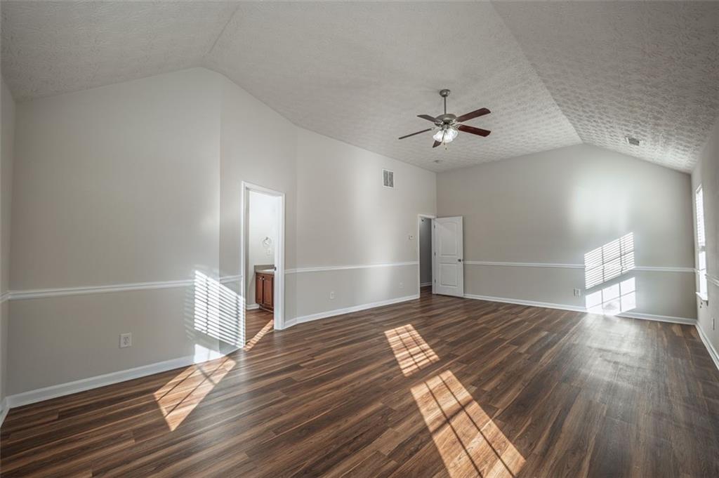 3017 Bellingham Way Lithia Springs, GA 30122 - Photo 21 of 44 a view of empty room with wooden floor and fan