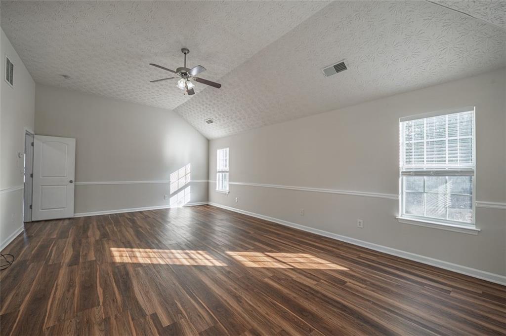 3017 Bellingham Way Lithia Springs, GA 30122 - Photo 22 of 44 wooden floor in an empty room with a window