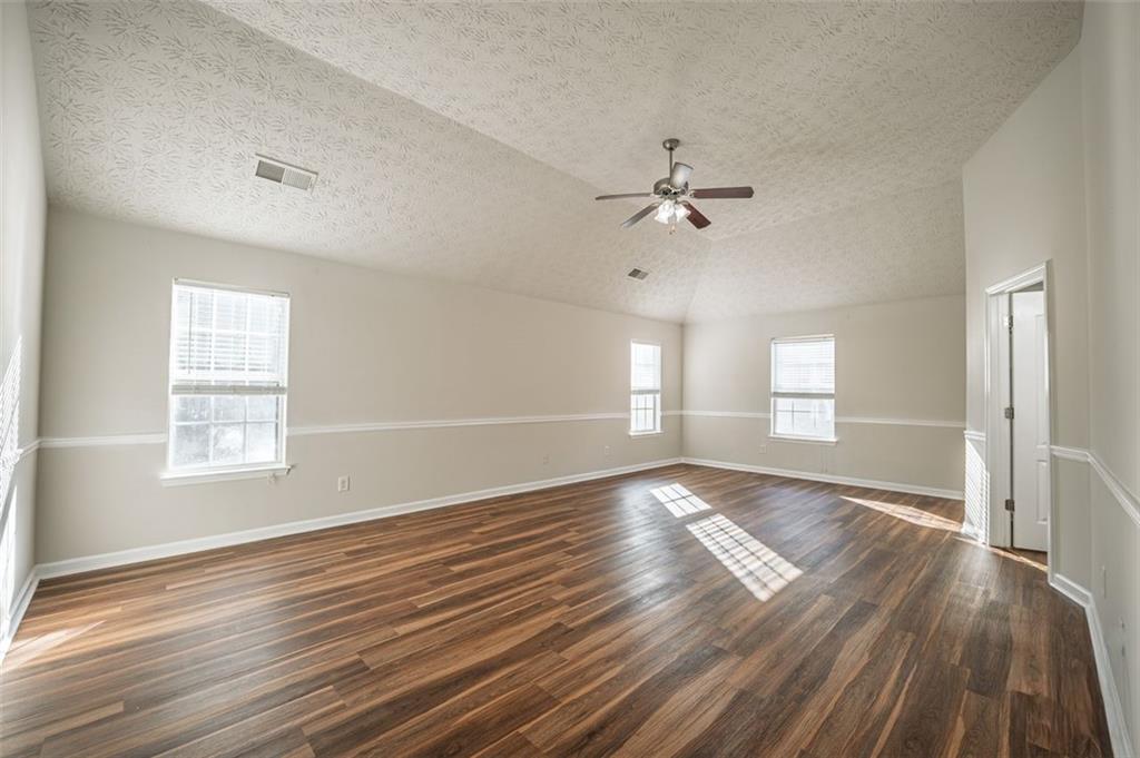3017 Bellingham Way Lithia Springs, GA 30122 - Photo 23 of 44 a view of an empty room with wooden floor and a window