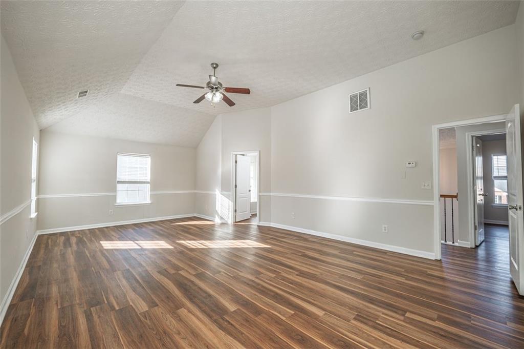 3017 Bellingham Way Lithia Springs, GA 30122 - Photo 24 of 44 wooden floor in an empty room with a window