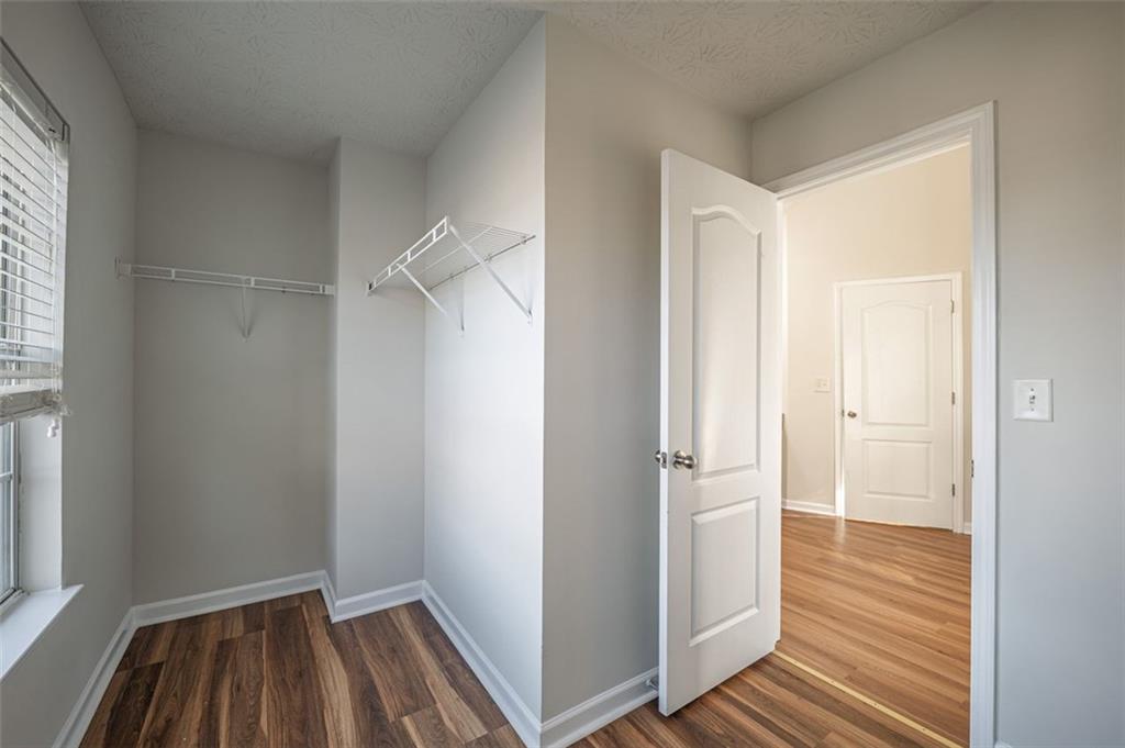 3017 Bellingham Way Lithia Springs, GA 30122 - Photo 27 of 44 a view of walk in closet with wooden floor