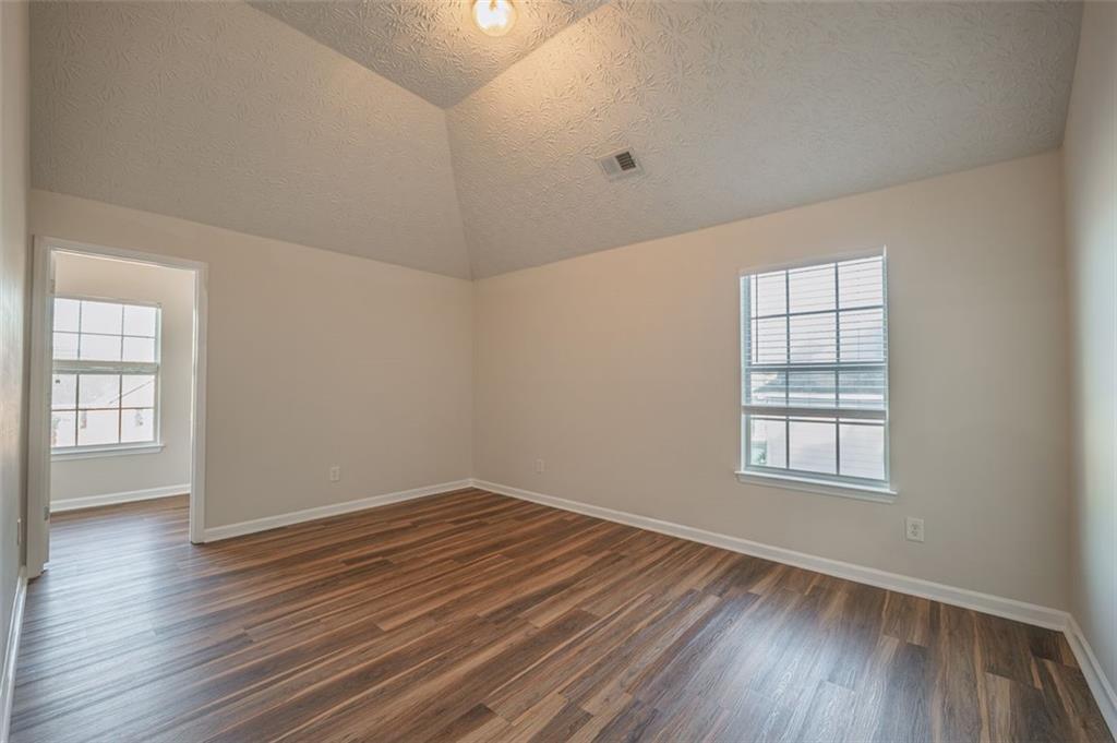 3017 Bellingham Way Lithia Springs, GA 30122 - Photo 34 of 44 an empty room with wooden floor and windows