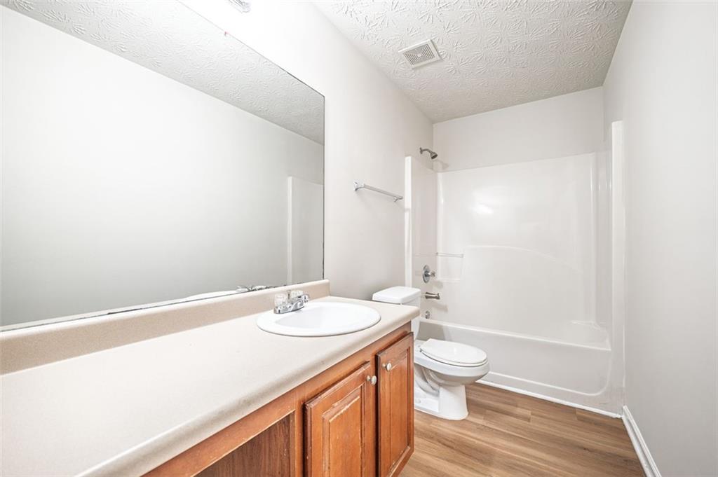 3017 Bellingham Way Lithia Springs, GA 30122 - Photo 39 of 44 a bathroom with a sink a toilet and shower