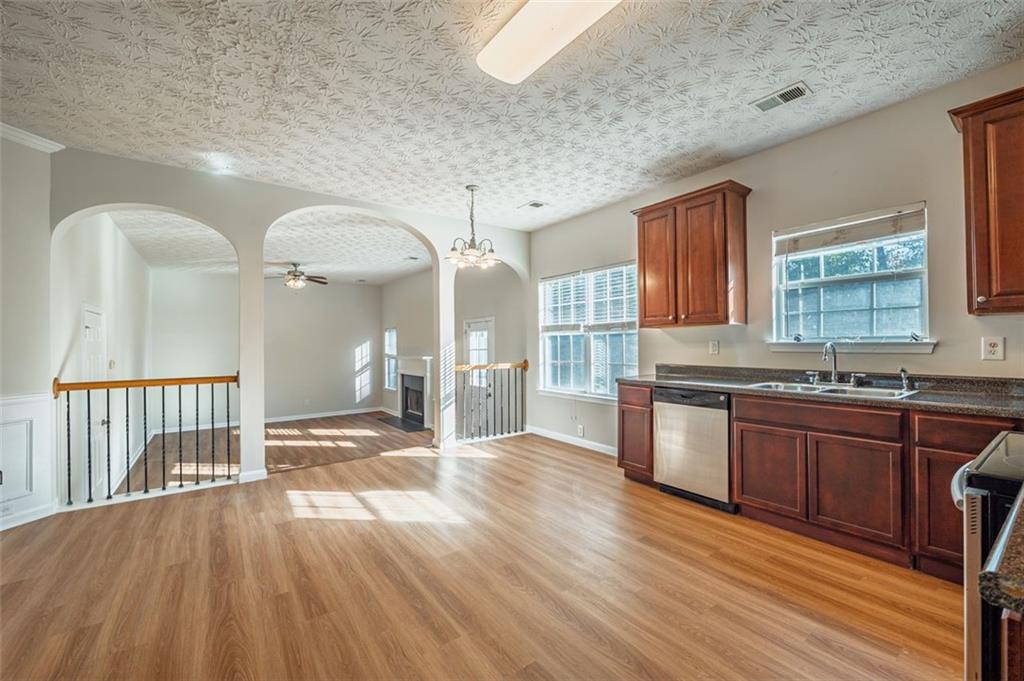 3017 Bellingham Way Lithia Springs, GA 30122 - Photo 6 of 44 a open kitchen with cabinets a sink and appliances