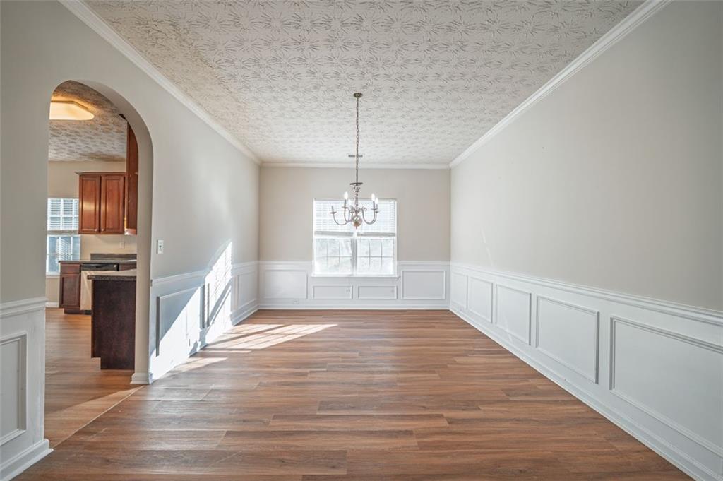 3017 Bellingham Way Lithia Springs, GA 30122 - Photo 10 of 44 wooden floor in an empty room with a window