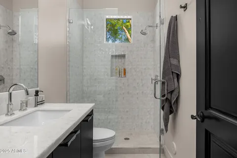 a large bed sitting in a bedroom next to a lamp