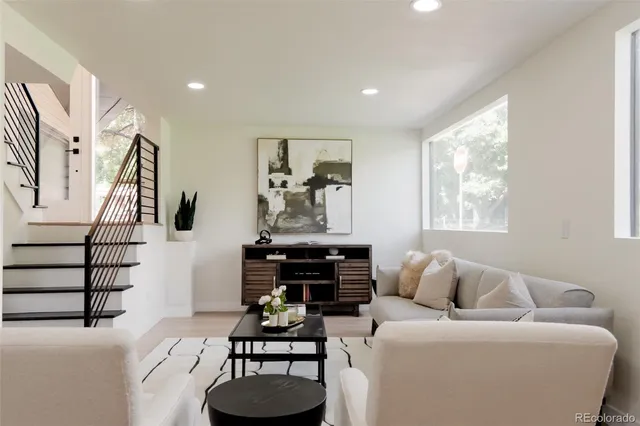 a living room with furniture a couch and a window