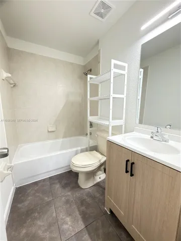 a bathroom with a sink a toilet and bathtub