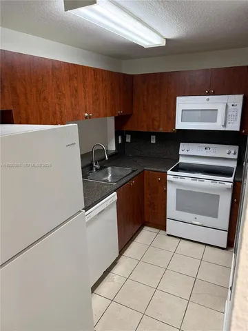 a kitchen with a stove top oven and cabinets