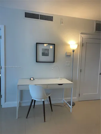 a view of a workspace with furniture