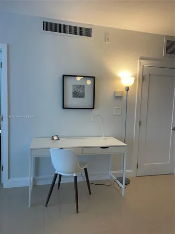 a view of a workspace with furniture