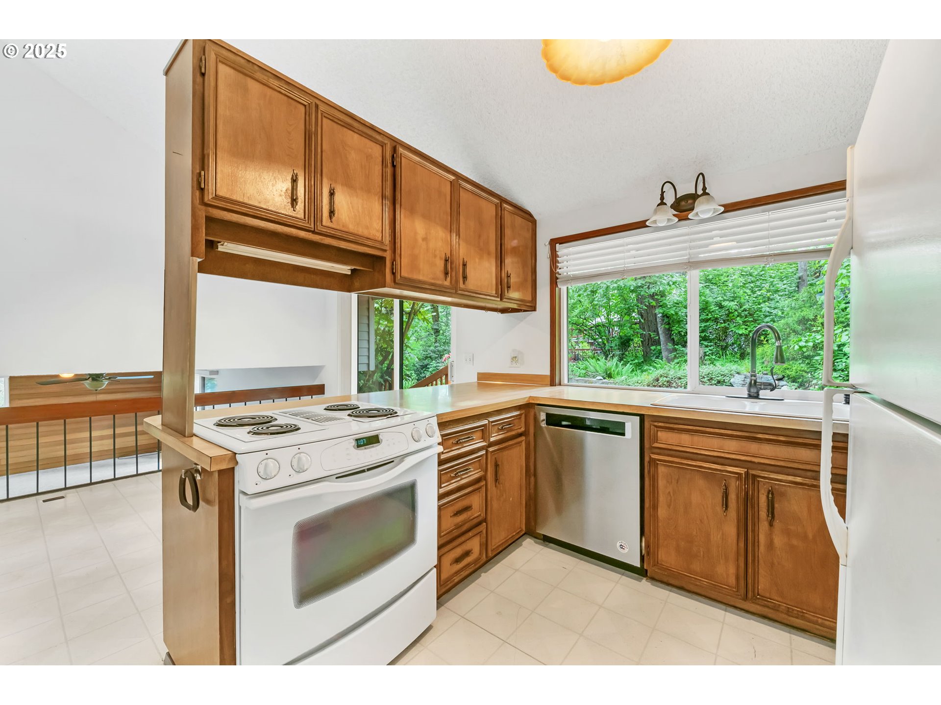 2811 Greentree Way Eugene, OR 97405 - Photo 11 of 38 a kitchen with a stove a sink and a microwave