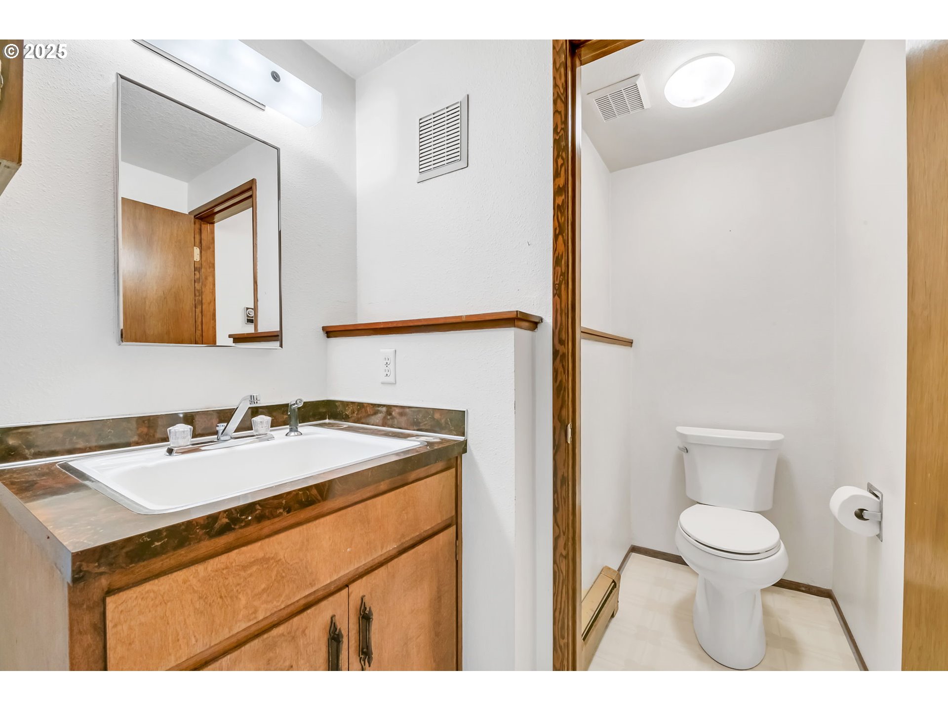 2811 Greentree Way Eugene, OR 97405 - Photo 18 of 38 a bathroom with a sink a toilet and a mirror