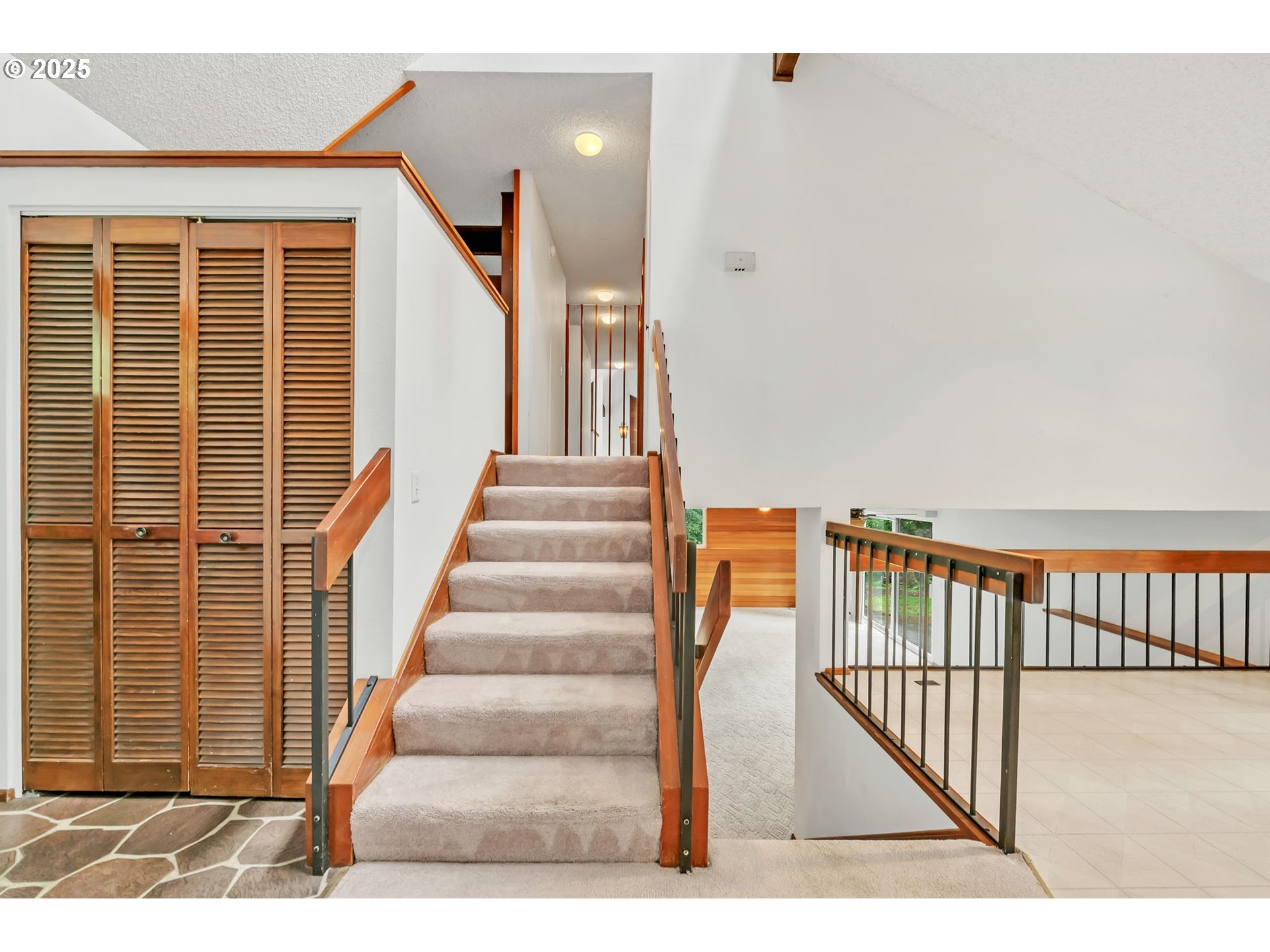2811 Greentree Way Eugene, OR 97405 - Photo 19 of 38 a view of staircase with white walls and a black gate
