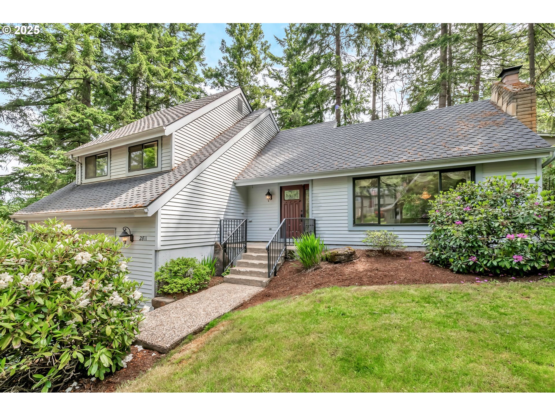 2811 Greentree Way Eugene, OR 97405 - Photo 2 of 38 a front view of a house with garden